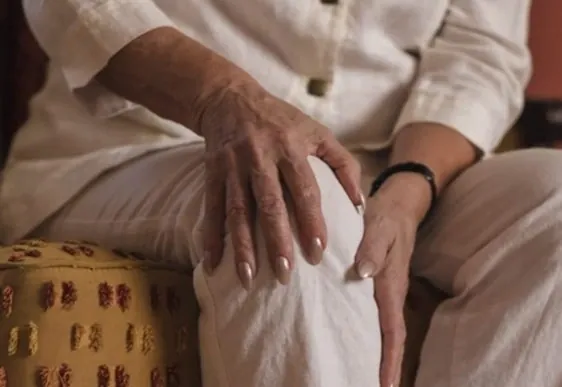 Hands resting on a knee