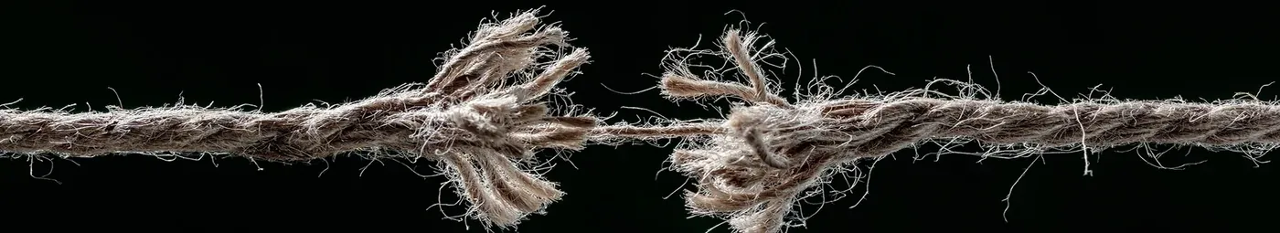 A frayed rope stretched across a wide banner