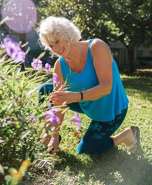 Woman kneeling in a garden bed